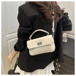 Side view of cream white PU leather square crossbody bag with silver rotating metal clasp