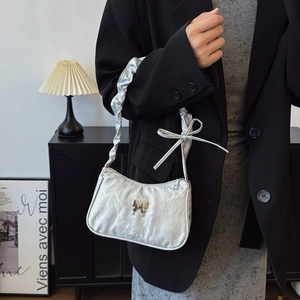 Silver metallic pleated shoulder bag with butterfly metal hardware and bow detail