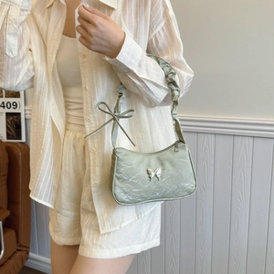 Pale green textured shoulder bag with silver butterfly and pleated cloud strap