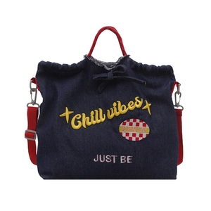 Deep blue denim tote bag with red handles and yellow Chill Vibes embroidery