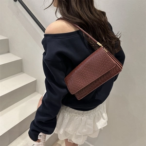 Brown woven texture baguette shoulder bag for women with minimalist aesthetic style