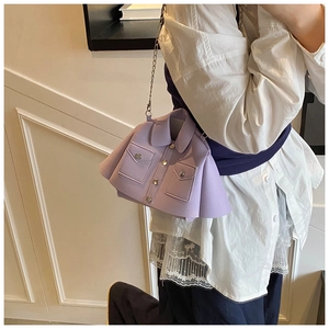 Detail of lavender jacket-style shoulder bag featuring leather texture and silver chain
