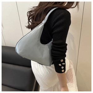 Detail showing the 'FASHION' embossed lettering on a glossy light blue hobo bag