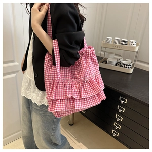 Detail showing pink and white checkered tote bag with elegant double ruffles on the side
