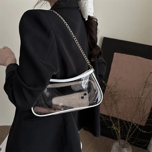 Minimalist clear PVC crescent shoulder bag with white trim and gold chain strap
