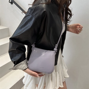 Women's minimalist lavender patent leather bucket bag with a knotted strap detail