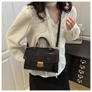 Détail du sac bandoulière noir effet croco avec boucle dorée et bandoulière en cuir