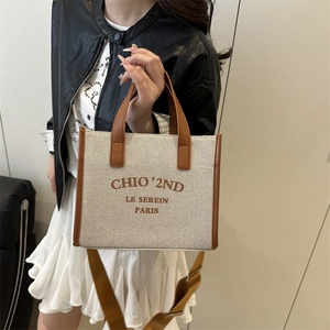 Minimalist large canvas tote bag with brown leather trim and detachable shoulder strap