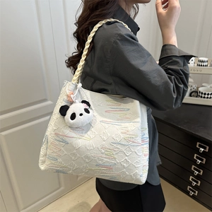 White tote bag with 3D embossed geometric texture and colorful embroidered waves