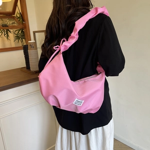 Chic pink ruched crescent bag with nylon fabric and wide pleated shoulder strap