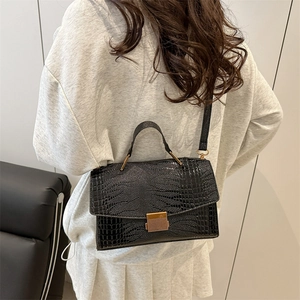 Luxury black crocodile embossed shell bag with gold hardware and shoulder strap for women