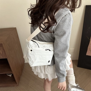 White minimalist shoulder bag with pleated texture and adjustable strap on a female model