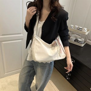 Sac bandoulière demi-lune blanc avec breloque peluche et pompons roses à l'épaule