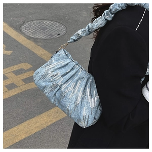 Detail of light blue sequined cloud bag with pleated texture and silver metallic finish