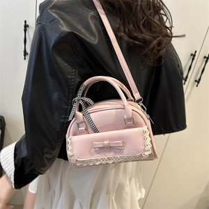 Pink PU shell bag with bow and lace trim shown as a crossbody shoulder purse