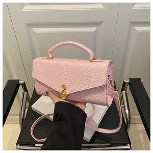 Pink faux crocodile leather handbag with woven handle and gold clasp detail