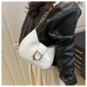 Detail of white crocodile texture crescent bag with gold U-shaped buckle and chain strap
