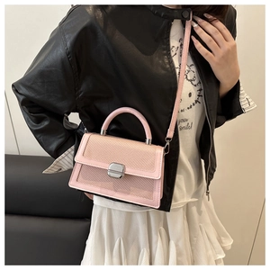 Detail of pink woven texture crossbody bag with silver push-lock and stylish top handle