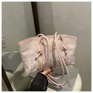 Detail of pink lace tote bag with 3D butterfly embroidery and knotted leather handle
