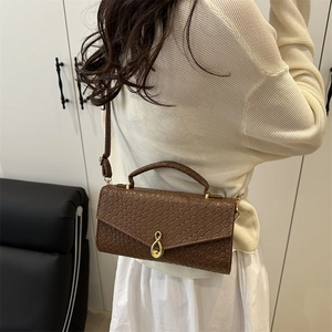 Brown woven texture shoulder bag with golden teardrop clasp for casual daily use