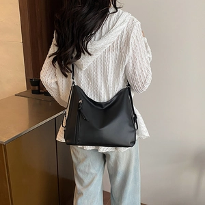 Chic black large capacity tote bag with adjustable strap and front zipper for daily use