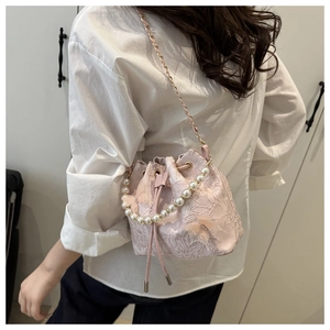 Pink lace bucket bag with 3D butterfly, pearl handle, and metal chain shoulder strap