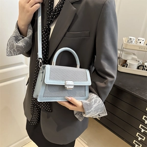 Light blue faux leather crossbody bag with woven texture panel and silver metal lock