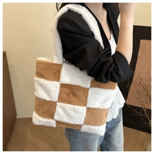 Brown and white checkerboard plush tote bag carried by model for casual winter look