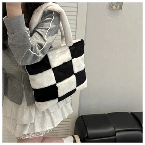 Detail view of high-density plush checkerboard tote bag with soft texture and wide handle