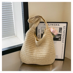 Close-up of large beige woven tote bag with hollow mesh texture in natural sunlight