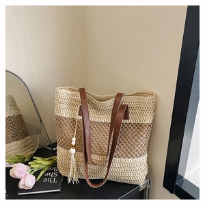 Detail of hand-woven tote bag with leather straps and decorative wooden bead tassels