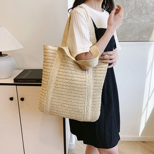 Minimalist beige woven straw tote bag for women with hollow mesh design for summer vacation