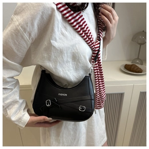 Fashionable black half-moon underarm bag with belt buckle detail worn by a model