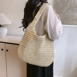 Chic woven straw tote bag for women, large capacity shoulder bag shown in a cozy home setting