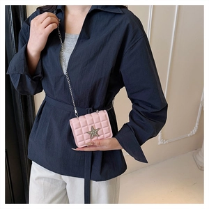 Detail of pink quilted PU leather mini bag with rhinestone star and silver chain strap