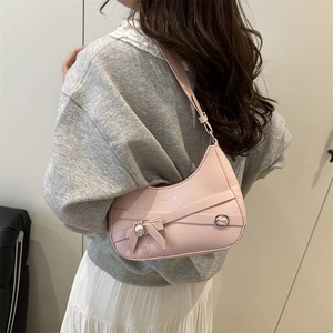 Pink crescent shoulder bag with strap buckle and Fashion text shown on model