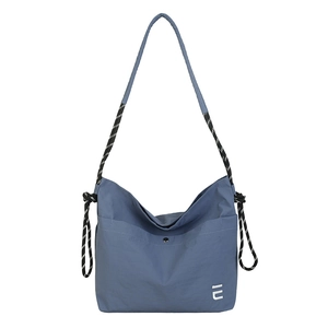 Blue waterproof nylon crossbody bag with large capacity and striped woven shoulder strap