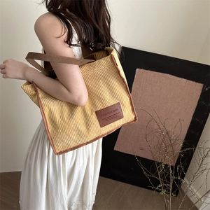 Spring yellow corduroy tote bag with brown woven handles for casual daily fashion