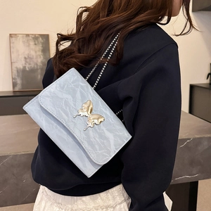 Chic light blue pleated shoulder bag with silver butterfly clasp and delicate chain strap