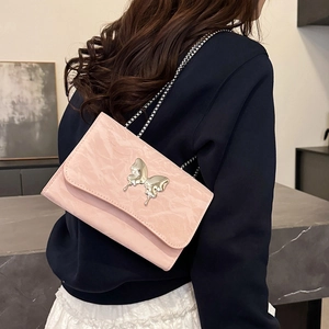 Pink chain crossbody bag with silver butterfly buckle and textured leather finish
