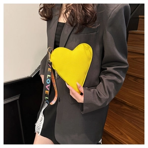Detailed shot of yellow heart-shaped bag with litchi texture and LOVE LOVE wristlet