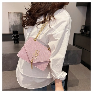 Pink glitter envelope crossbody bag with gold G logo, tassel detail and chain strap