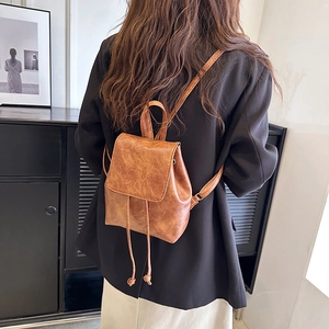 Minimalist brown faux leather mini backpack with drawstring and flap closure for women