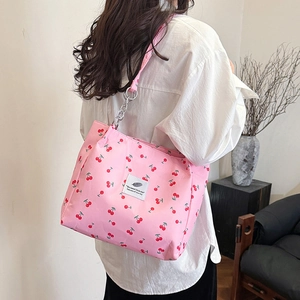Chic pink tote bag with cherry print and silver chain strap for spring 2025 fashion
