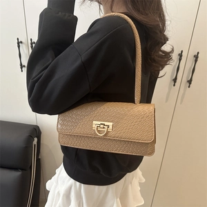 Brown crocodile-embossed baguette shoulder bag with gold horseshoe buckle closure