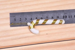 Detailed view of an 8.5cm white and gold spiral candy cane ornament with hanging loop