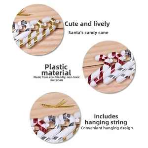 Detail of candy cane ornaments with metallic stripes and gold hanging strings