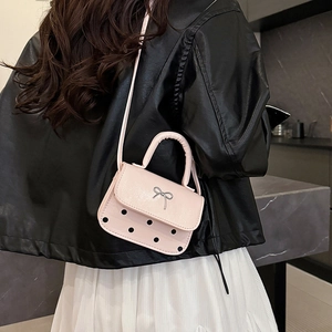 Pink mini crossbody bag with silver bow and black polka dots for women casual style