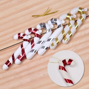 Set of 6 Christmas candy cane ornaments in red, silver and gold stripes on wood surface