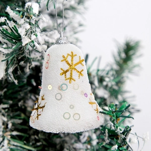 White foam Christmas bell ornaments with golden snowflakes and colorful sequins on a tree